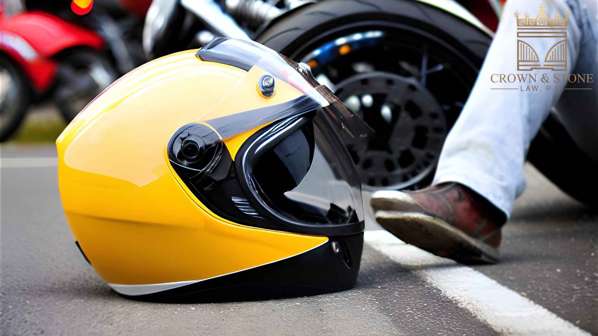 Yellow motorcycle helmet on road near bike wheel.