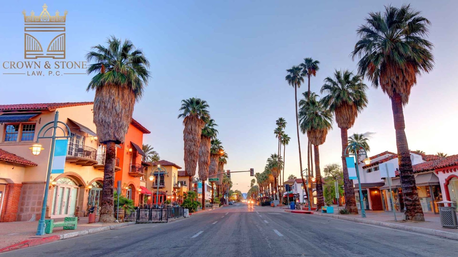 Palm tree-lined street at sunset, vibrant buildings