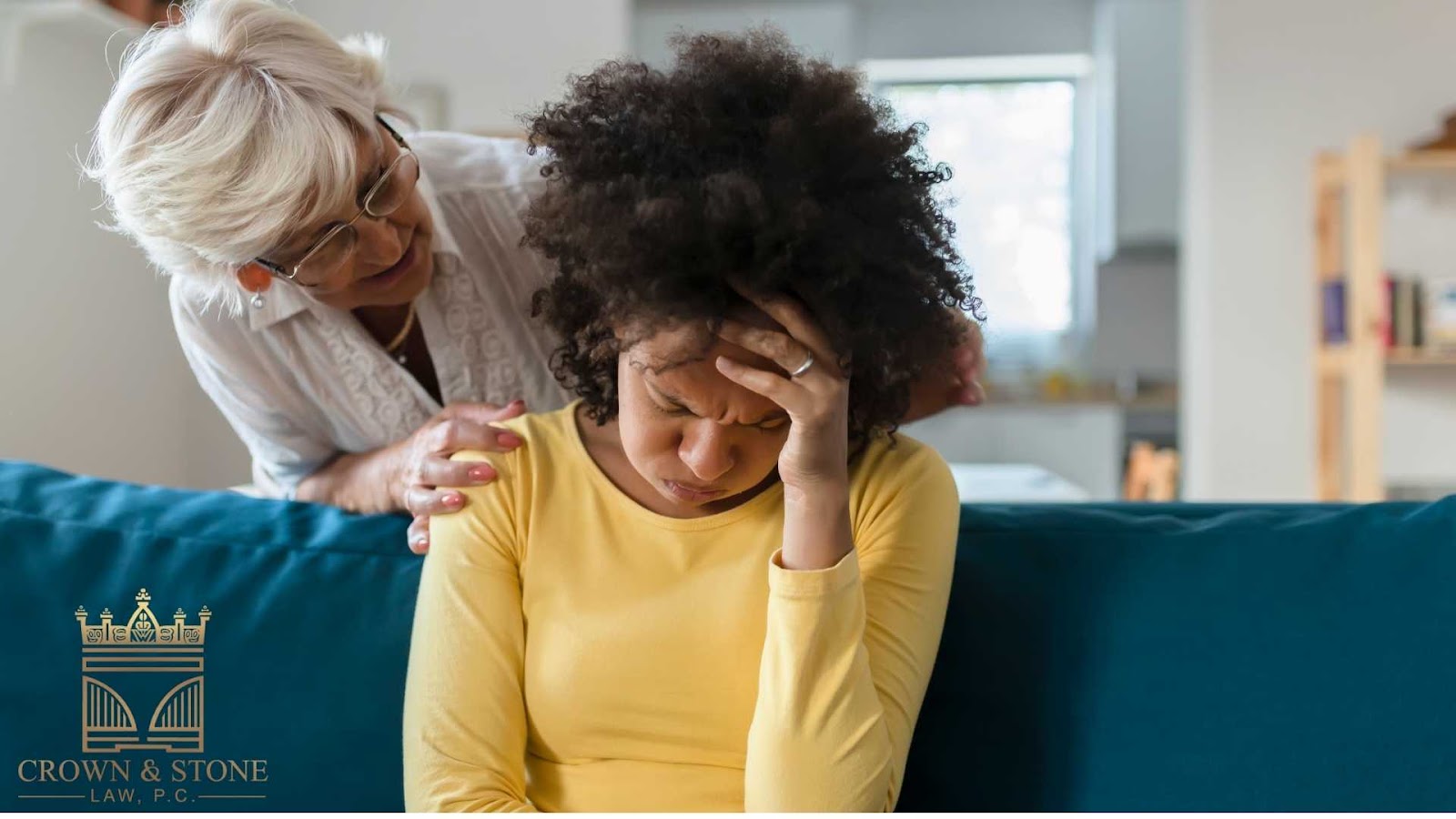 Concerned woman comforting another on couch