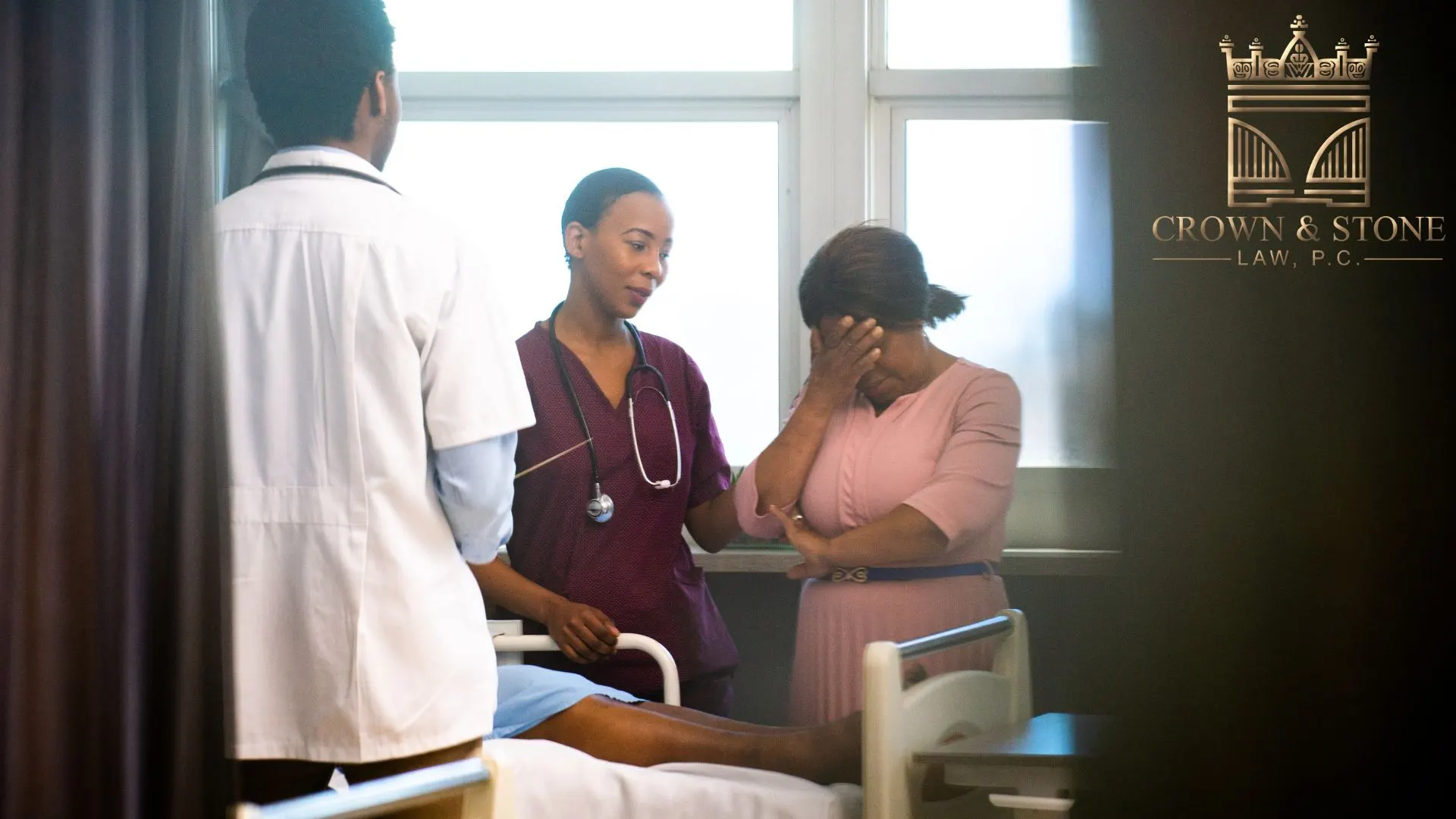 Doctors comforting upset woman in hospital room