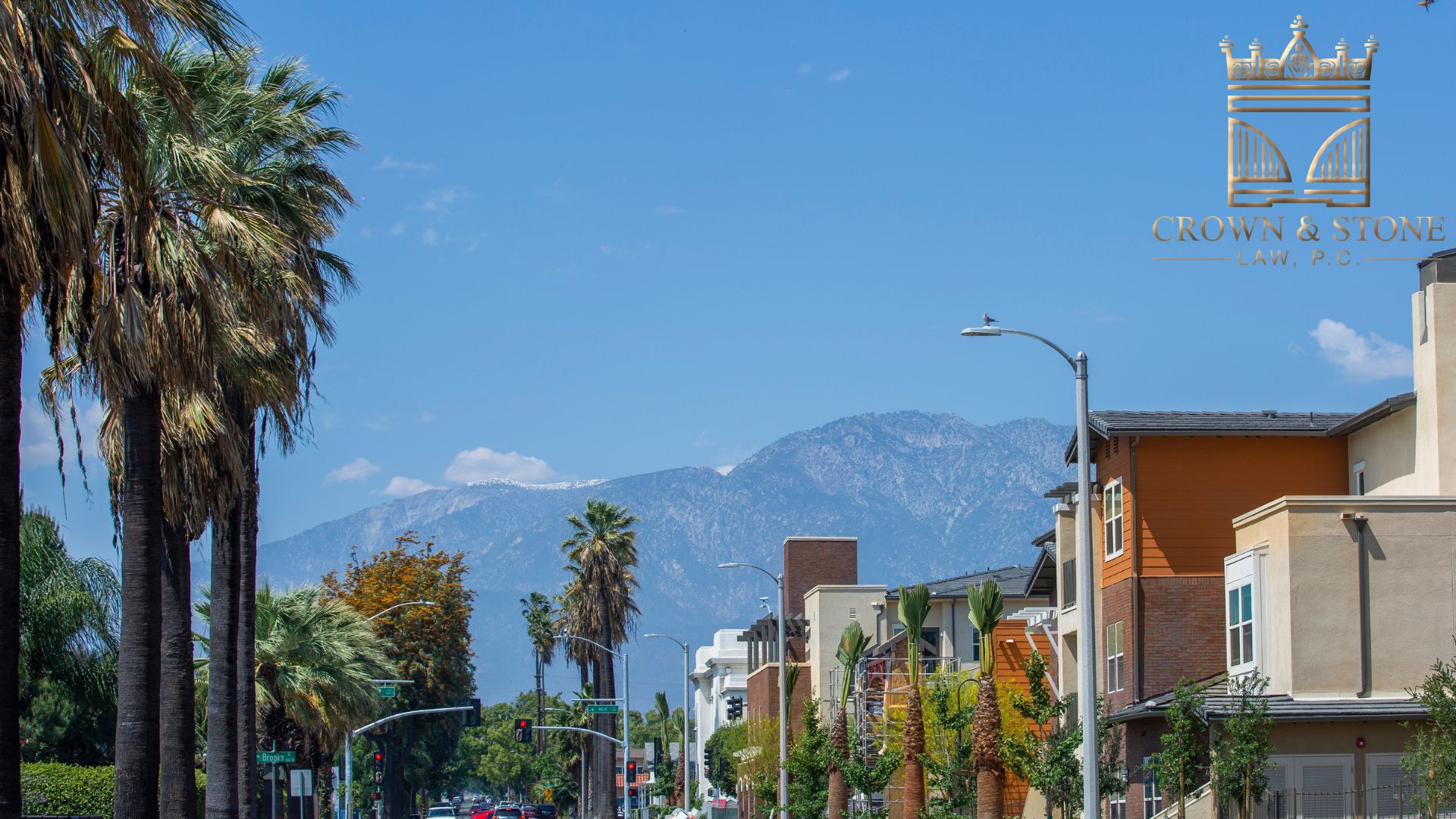 A commercial street in California with building and palm trees on either side, here bicycle accidents offer occur.