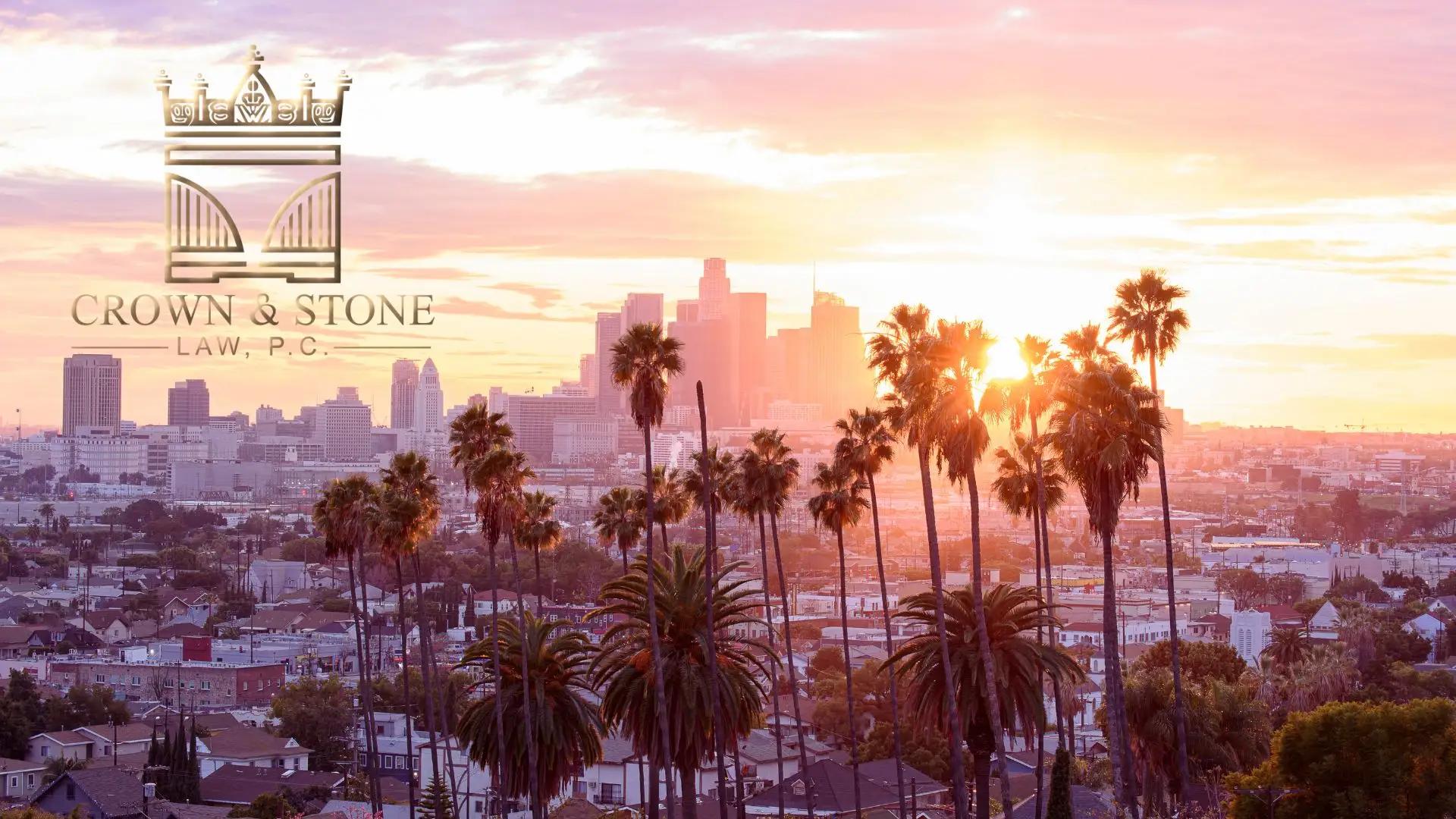 Los Angeles skyline at sunset with palm trees
